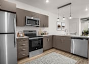 Thumbnail 17 of 28 - A modern kitchen with stainless steel appliances and wooden cabinets.