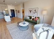 Thumbnail 43 of 49 - A living room with a grey rug and a white chair.