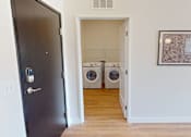 Thumbnail 44 of 49 - A laundry room with a washer and dryer in it.