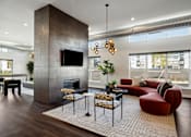 Thumbnail 4 of 49 - A modern living room with a fireplace and a television.