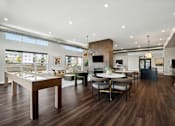 Thumbnail 6 of 49 - A modern living room with a wooden floor and furniture.