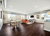 Thumbnail 12 of 49 - A modern living room with a white dining table and chairs.
