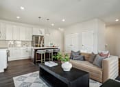 Thumbnail 20 of 49 - A modern kitchen with white cabinets and a large island.