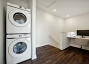 Thumbnail 25 of 49 - A white washing machine and dryer in a laundry room.