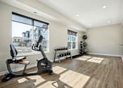 Thumbnail 9 of 49 - A home gym with a treadmill, weights, and exercise equipment.