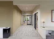 Thumbnail 18 of 28 - A hallway with a chair, a table, and a trash can.
