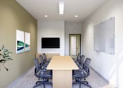 Thumbnail 27 of 28 - A conference room with a long table and chairs.