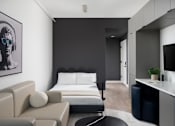 Thumbnail 14 of 24 - A modern bedroom with a large bed and a couch at Miles at Ybor Apartments, Florida