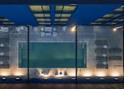 Thumbnail 9 of 24 - A modern building with a glass facade and a stone wall at Miles at Ybor Apartments, Tampa, Florida