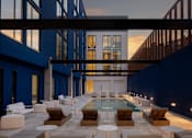 Thumbnail 8 of 24 - A modern outdoor pool area with lounge chairs and tables at Miles at Ybor Apartments, Tampa, FL