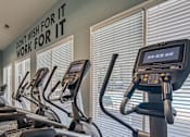 Thumbnail 13 of 37 - A gym with treadmills and a sign that says "Don't wish for it, work for it.".