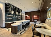 Thumbnail 3 of 19 - A modern restaurant with a bar area and wooden floors.