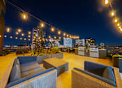 Thumbnail 2 of 24 - a roof top bar with a view of the city at night at ELEVATE Apartment Homes, Minnesota, 55403