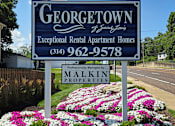 Thumbnail 25 of 26 - A blue sign for Georgetown Exceptional Rental Apartment Homes with a phone number and the name Malkin Properties.