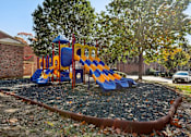 Thumbnail 20 of 33 - A playground with a blue and yellow slide.
