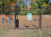 Thumbnail 28 of 33 - A black fence with a sign that says "DOG PARK" on it.