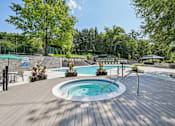 Thumbnail 23 of 33 - Resort-style pool and hot tub with deck seating and gazebo at River Oaks at Rochester Hills.