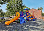 Thumbnail 38 of 43 - A new playground with a yellow slide and a blue and yellow climbing structure at Georgetown of St. Louis Apartments