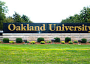 Thumbnail 32 of 33 - Oakland University entrance sign near River Oaks at Rochester Hills Apartments & Townhomes in Rochester Hills MI.