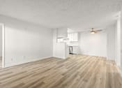 Thumbnail 10 of 36 - A room with wooden flooring and white walls.