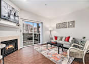 Thumbnail 2 of 45 - A living room with a fireplace and a couch.
