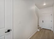 Thumbnail 23 of 23 - A white door with a black handle is on the left side of the image at Bloom Rental Living apartments in Fort Collins, CO.