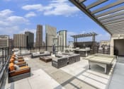 Thumbnail 29 of 29 - a rooftop patio with furniture and a view of the city