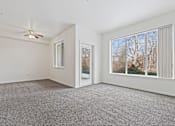 Thumbnail 13 of 19 - A room with a carpeted floor and a ceiling fan.