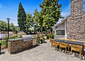Thumbnail 42 of 42 - a patio with a grill and a table with yellow chairs
