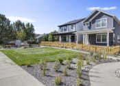 Thumbnail 20 of 51 - a blue house with a yard and a sidewalk