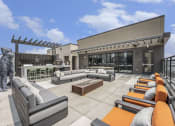 Thumbnail 7 of 29 - a rooftop patio with couches and a dog statue