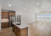 Thumbnail 15 of 23 - A kitchen with wooden cabinets and a stainless steel refrigerator. at Bloom Rental Living apartments in Fort Collins, CO.