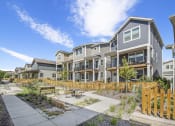 Thumbnail 14 of 51 - an outdoor area with a picnic table in front of an apartment building