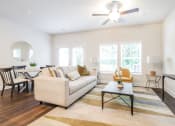Thumbnail 53 of 60 - a living room with a couch coffee table and a ceiling fan