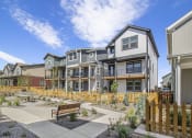 Thumbnail 50 of 51 - a group of townhomes with benches in a courtyard