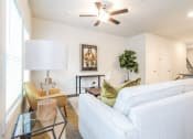 Thumbnail 54 of 60 - a living room with white walls and a ceiling fan