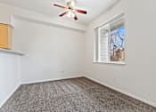 Thumbnail 15 of 19 - A room with a ceiling fan and a window.