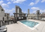 Thumbnail 6 of 29 - a rooftop pool with a city skyline in the background