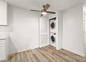 Thumbnail 15 of 36 - A white laundry room with a washer and dryer.