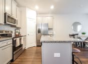 Thumbnail 52 of 60 - a kitchen with white cabinetry and a granite counter top