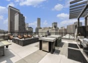 Thumbnail 27 of 29 - a rooftop terrace with tables and a view of the city
