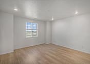 Thumbnail 14 of 23 - A room with a window and wooden flooring at Bloom Rental Living apartments in Fort Collins, CO.