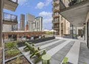 Thumbnail 25 of 29 - the terrace of a building with tables and chairs and a city in the background