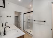 Thumbnail 22 of 23 - A white bathroom with a sink and mirror at Bloom Rental Living apartments in Fort Collins, CO.