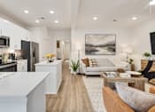 Thumbnail 8 of 37 - A modern kitchen with a long wooden table in the middle of the room.