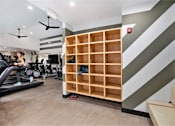 Thumbnail 38 of 45 - A woman is working out on a treadmill in a gym.