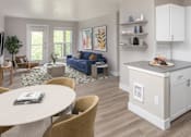 Thumbnail 2 of 29 - A modern kitchen with a dining table and chairs.