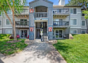 Thumbnail 51 of 52 - Apartment building with a red sign on the door.