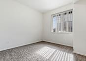 Thumbnail 16 of 19 - A room with a window and a carpet on the floor.