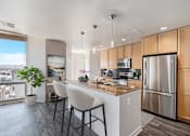 Thumbnail 30 of 33 - A modern kitchen with wooden cabinets and stainless steel appliances. at 1600 Glenarm Place, Colorado, 80202